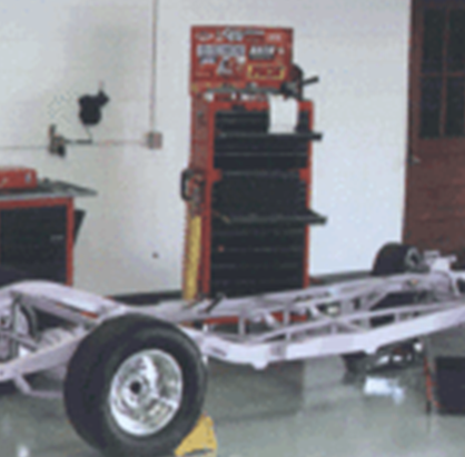 A car in a garage with tools on it.